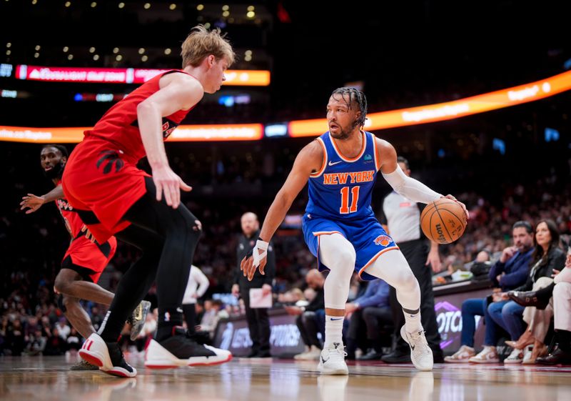 TORONTO, ON - MARCH 27: Jalen Brunson #11 of the New York Knicks dribbles against Gradey Dick #1 of the Toronto Raptors during the first half of their basketball game at the Scotiabank Arena on March 27, 2024 in Toronto, Ontario, Canada. NOTE TO USER: User expressly acknowledges and agrees that, by downloading and/or using this Photograph, user is consenting to the terms and conditions of the Getty Images License Agreement. (Photo by Mark Blinch/Getty Images)