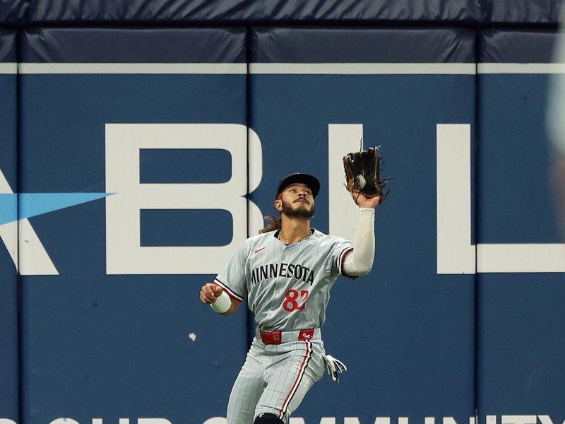 Sep 3, 2024; St. Petersburg, Florida, USA;  Minnesota Twins outfielder Austin Martin (82) catches a fly ball against the Tampa Bay Rays during the first inning at Tropicana Field. Mandatory Credit: Kim Klement Neitzel-Imagn Images