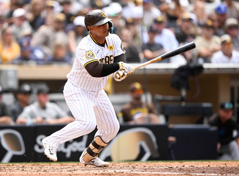 May 29, 2024; San Diego, California, USA; San Diego Padres third baseman Donovan Solano (39) hits a single during the fourth inning against the Miami Marlins  at Petco Park. Mandatory Credit: Denis Poroy-USA TODAY Sports