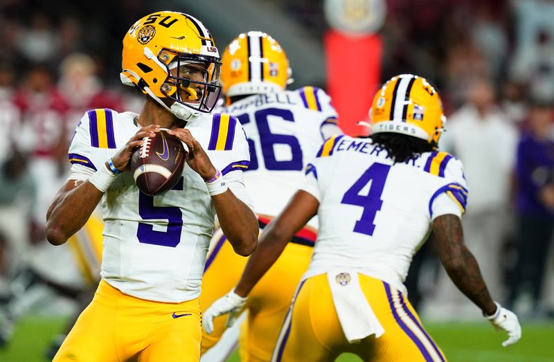 Nov 4, 2023; Tuscaloosa, Alabama, USA; LSU Tigers quarterback Jayden Daniels (5) drops back to pass against the Alabama Crimson Tide during the second quarter at Bryant-Denny Stadium. Mandatory Credit: John David Mercer-USA TODAY Sports