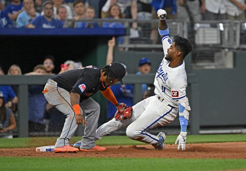 Jun 27, 2024; Kansas City, Missouri, USA;  Kansas City Royals second baseman Maikel Garcia (11) slides into third base against Cleveland Guardians third baseman Jose Ramirez (11) after hitting a RBI triple in the sixth inning at Kauffman Stadium. Mandatory Credit: Peter Aiken-USA TODAY Sports