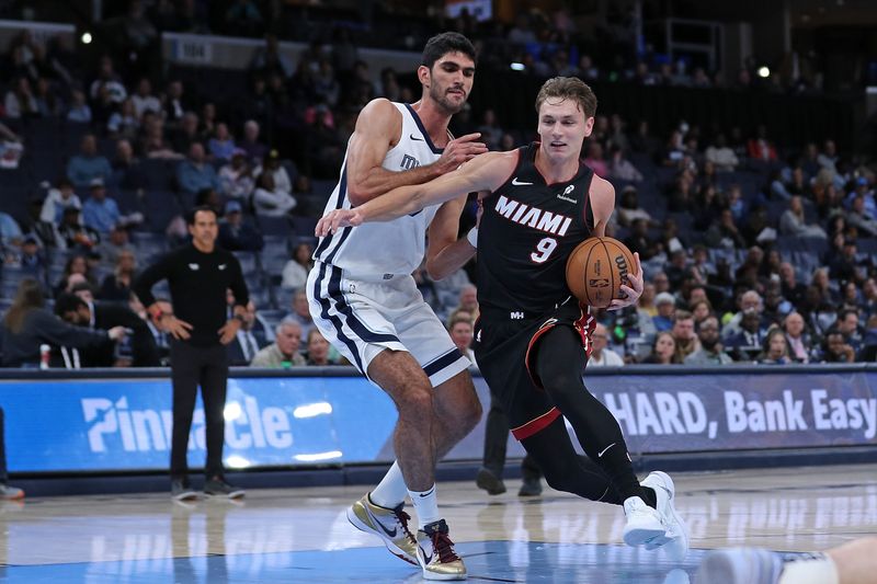 MEMPHIS, TENNESSEE - OCTOBER 18: Pelle Larsson #9 of the Miami Heat drives to the basket against Santi Aldama #7 of the Memphis Grizzlies during the first half at FedExForum on October 18, 2024 in Memphis, Tennessee. NOTE TO USER: User expressly acknowledges and agrees that, by downloading and or using this photograph, User is consenting to the terms and conditions of the Getty Images License Agreement. (Photo by Justin Ford/Getty Images)