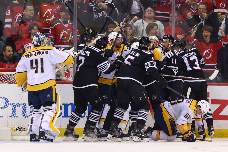 Nov 25, 2024; Newark, New Jersey, USA; The New Jersey Devils and the Nashville Predators fight after a hit by New Jersey Devils right wing Timo Meier (28) (not shown) during the third period at Prudential Center. Mandatory Credit: Ed Mulholland-Imagn Images