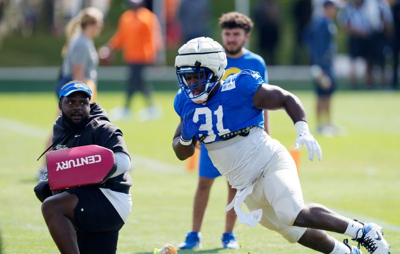 Los Angeles Rams defensive tackle Kobie Turner warms up before facing the Denver Broncos during an NFL football training camp practice Wednesday, Aug. 23, 2023, at the Broncos' headquarters in Centennial, Colo. (AP Photo/David Zalubowski)