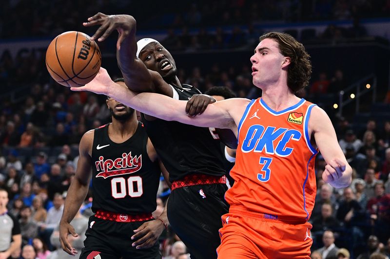 OKLAHOMA CITY, OKLAHOMA - JANUARY 23: Josh Giddey #3 of the Oklahoma City Thunder and Duop Reath #26 of the Portland Trail Blazers go after a loose ball during the first half at Paycom Center on January 23, 2024 in Oklahoma City, Oklahoma. NOTE TO USER: User expressly acknowledges and agrees that, by downloading and or using this Photograph, user is consenting to the terms and conditions of the Getty Images License Agreement. (Photo by Joshua Gateley/Getty Images)