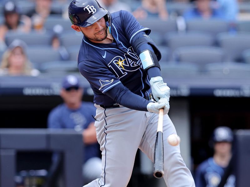 Jul 20, 2024; Bronx, New York, USA; Tampa Bay Rays catcher Alex Jackson (28) hits a three run home run against the New York Yankees during the fourth inning at Yankee Stadium. Mandatory Credit: Brad Penner-USA TODAY Sports