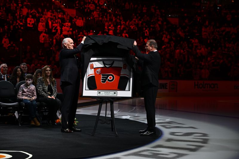 Jan 27, 2024; Philadelphia, Pennsylvania, USA; Philadelphia Flyers former player Mark Recchi (right) unveils his jersey during his induction ceremony into the Flyers Hall of Fame before a game against the Boston Bruins at Wells Fargo Center. Mandatory Credit: Kyle Ross-USA TODAY Sports
