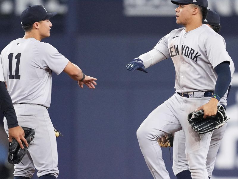 Jun 30, 2024; Toronto, Ontario, CAN; New York Yankees right fielder Juan Soto (22) celebrates the win with shortstop Anthony Volpe (11) against the Toronto Blue Jays at the end of the ninth inning at Rogers Centre. Mandatory Credit: Nick Turchiaro-USA TODAY Sports