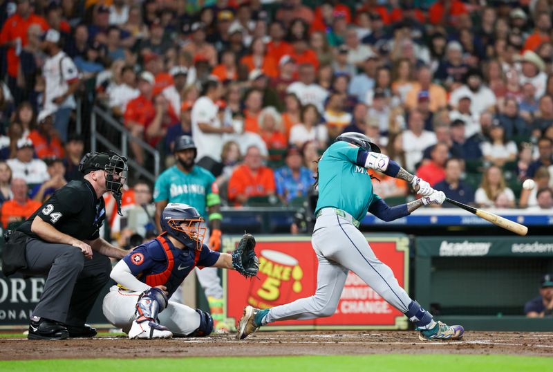 Sep 21, 2025; Houston, Texas, USA;  Seattle Mariners shortstop J.P. Crawford (3) hits a grand slam against the Houston Astros in the second inning at Daikin Park. Mandatory Credit: Thomas Shea-Imagn Images