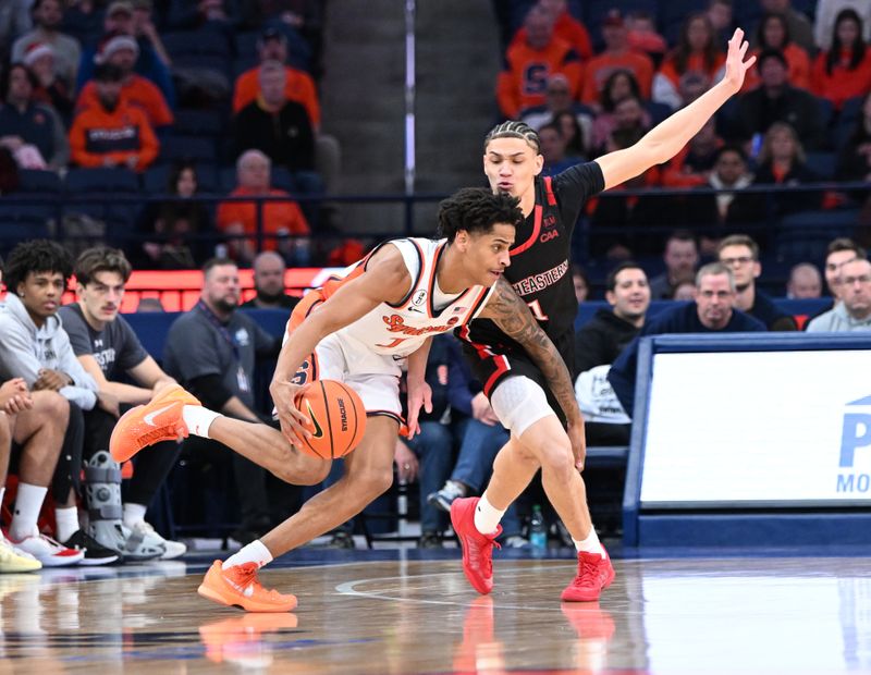 Dec 20, 2025; Syracuse, New York, USA; Syracuse Orange forward Kiyan Anthony (7) moves the ball past Northeastern Huskies guard Xavier Abreu (1) in the first half at the JMA Wireless Dome. Mandatory Credit: Mark Konezny-Imagn Images