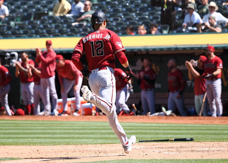 May 17, 2023; Oakland, California, USA; Arizona Diamondbacks left fielder Lourdes Gurriel Jr. (12) scores a run against the Oakland Athletics during the ninth inning at Oakland-Alameda County Coliseum. Mandatory Credit: Kelley L Cox-USA TODAY Sports