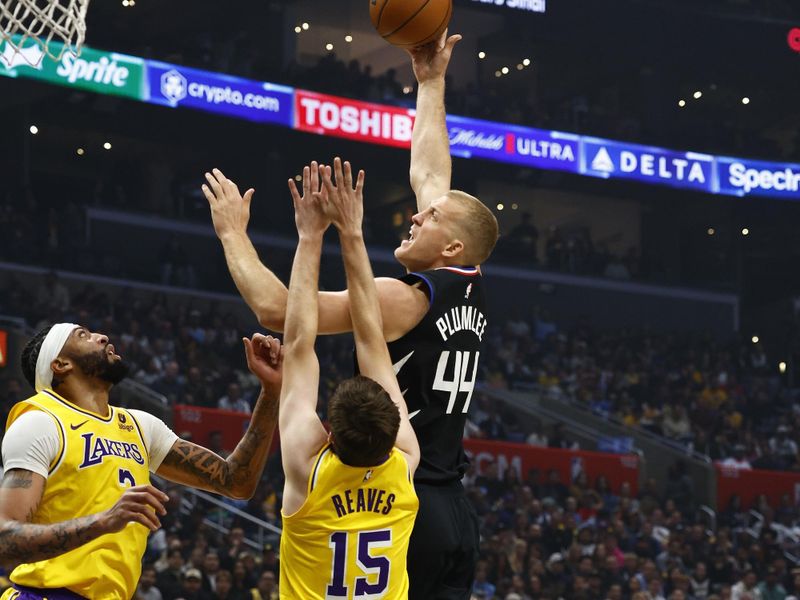 LOS ANGELES, CALIFORNIA - FEBRUARY 28:  Mason Plumlee #44 of the LA Clippers takes a shot against Anthony Davis #3 and Austin Reaves #15 of the Los Angeles Lakers in the first half at Crypto.com Arena on February 28, 2024 in Los Angeles, California.  NOTE TO USER: User expressly acknowledges and agrees that, by downloading and/or using this photograph, user is consenting to the terms and conditions of the Getty Images License Agreement.  (Photo by Ronald Martinez/Getty Images)