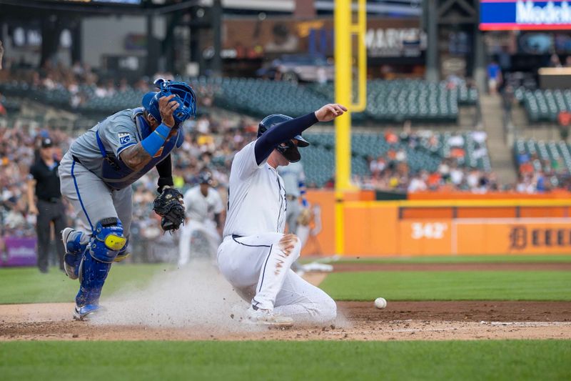 Aug 1, 2024; Detroit, Michigan, USA; Detroit Tigers second base Colt Keith (33) beats the throw to Kansas City Royals catcher Salvador Perez (13) and scores a run in the fourth inning at Comerica Park. Mandatory Credit: David Reginek-USA TODAY Sports