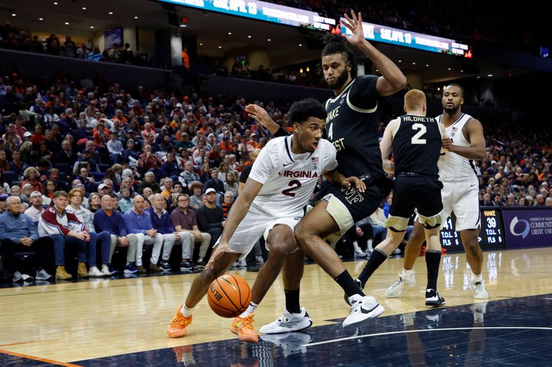 Feb 17, 2024; Charlottesville, Virginia, USA; Virginia Cavaliers guard Reece Beekman (2) drives to the basket as Wake Forest Demon Deacons forward Efton Reid III (4) defends in the second half at John Paul Jones Arena. Mandatory Credit: Geoff Burke-USA TODAY Sports