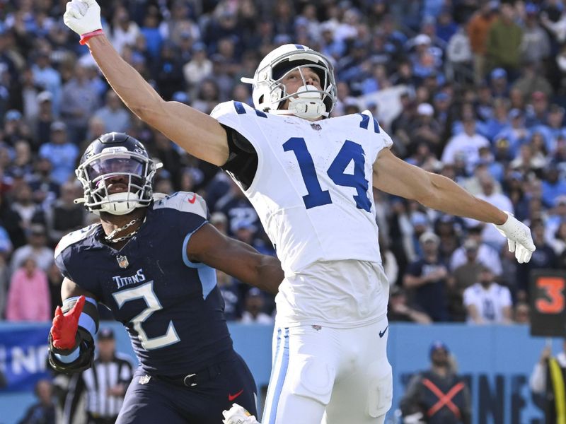 Indianapolis Colts wide receiver Alec Pierce (14) misses a pass as Tennessee Titans linebacker Azeez Al-Shaair (2) defends during an NFL football game, Monday, Dec. 4, 2023, in Nashville, Tenn. (AP Photo/John Amis)