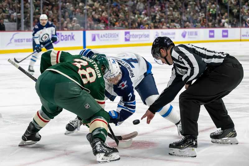 Nov 25, 2024; Saint Paul, Minnesota, USA;  Minnesota Wild forward Ryan Hartman (38) and Winnipeg Jets forward Vladislav Namestnikov (7) face-off during the third period at Xcel Energy Center. Mandatory Credit: Nick Wosika-Imagn Images