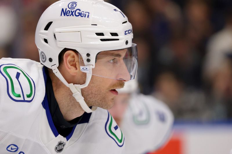 Nov 29, 2024; Buffalo, New York, USA;  Vancouver Canucks defenseman Carson Soucy (7) waits for the face-off during the second period against the Buffalo Sabres at KeyBank Center. Mandatory Credit: Timothy T. Ludwig-Imagn Images