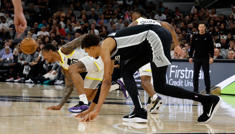 SAN ANTONIO, TX - NOVEMBER 9:  John Collins #20 of the Utah Jazz steals the ball from Victor Wembanyama #1 of the San Antonio Spurs in the first half at Frost Bank Center on November 9, 2024 in San Antonio, Texas. NOTE TO USER: User expressly acknowledges and agrees that, by downloading and or using this photograph, User is consenting to terms and conditions of the Getty Images License Agreement. (Photo by Ronald Cortes/Getty Images)