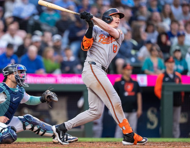 Jun 4, 2025; Seattle, Washington, USA;  Balitimore Orioles right fielderHeston Kjerstad (13) hits a two-run triple during the seventh inning against the Seattle Mariners at T-Mobile Park. Mandatory Credit: Stephen Brashear-Imagn Images