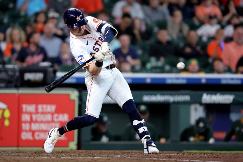 May 28, 2025; Houston, Texas, USA; Houston Astros designated hitter Zach Dezenzo (9) hits a solo home run to center field against the Athletics during the seventh inning at Daikin Park. Mandatory Credit: Erik Williams-Imagn Images