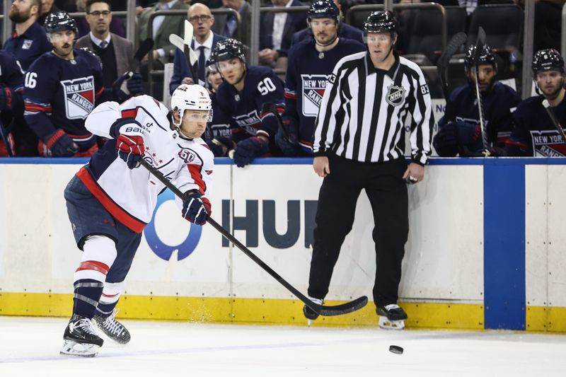 Mar 5, 2025; New York, New York, USA;  Washington Capitals defenseman Jakob Chychrun (6) attempts a shot on goal in the first period against the New York Rangers at Madison Square Garden. Mandatory Credit: Wendell Cruz-Imagn Images