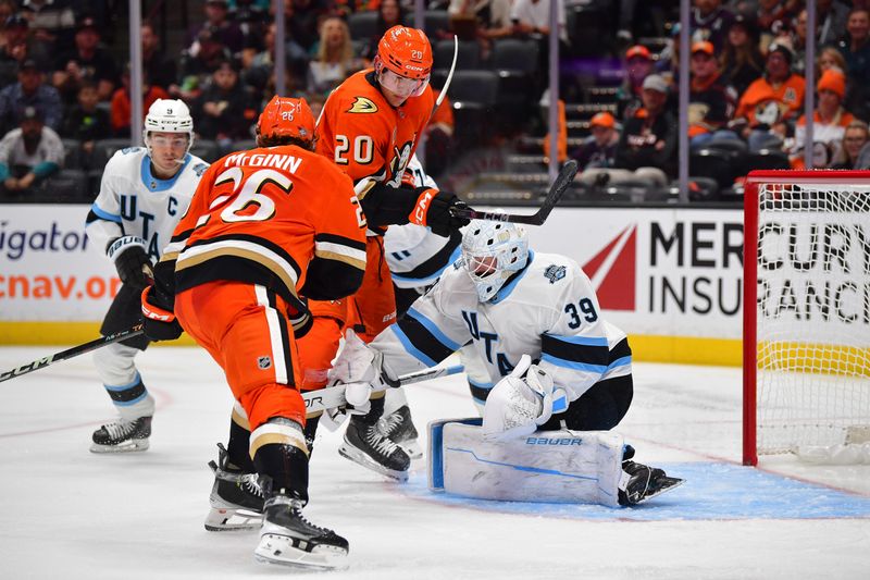 Oct 16, 2024; Anaheim, California, USA; Utah Hockey Club goaltender Connor Ingram (39) defends the goal against Anaheim Ducks left wing Brock McGinn (26) and right wing Brett Leason (20) during the second period at Honda Center. Mandatory Credit: Gary A. Vasquez-Imagn Images