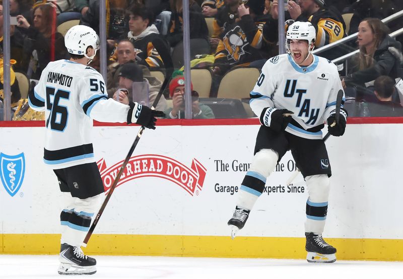 Dec 14, 2025; Pittsburgh, Pennsylvania, USA;  Utah Mammoth defenseman Sean Durzi (50) reacts with right wing Kailer Yamamoto (56) after scoring a third period goal against the Pittsburgh Penguins at PPG Paints Arena. Mandatory Credit: Charles LeClaire-Imagn Images