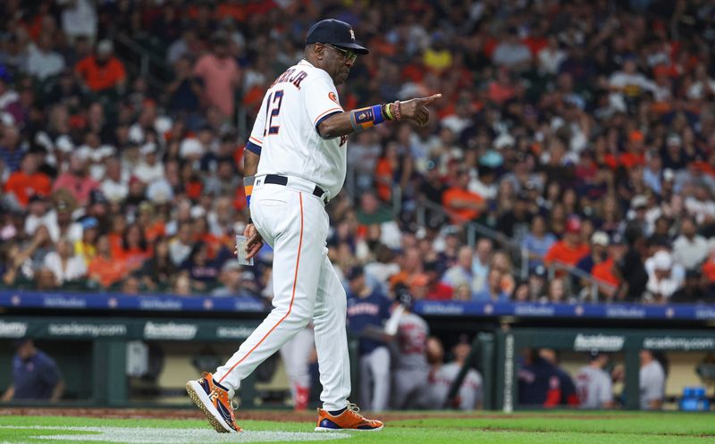 Aug 23, 2023; Houston, Texas, USA; Houston Astros manager Dusty Baker Jr. (12) calls for a pitching change during the fifth inning against the Boston Red Sox at Minute Maid Park. Mandatory Credit: Troy Taormina-USA TODAY Sports