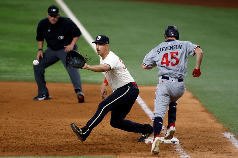 Sep 2, 2023; Arlington, Texas, USA; Texas Rangers first baseman Nathaniel Lowe (30) makes the put out at first base of Minnesota Twins center fielder Andrew Stevenson (45) in the sixth inning at Globe Life Field. Mandatory Credit: Tim Heitman-USA TODAY Sports