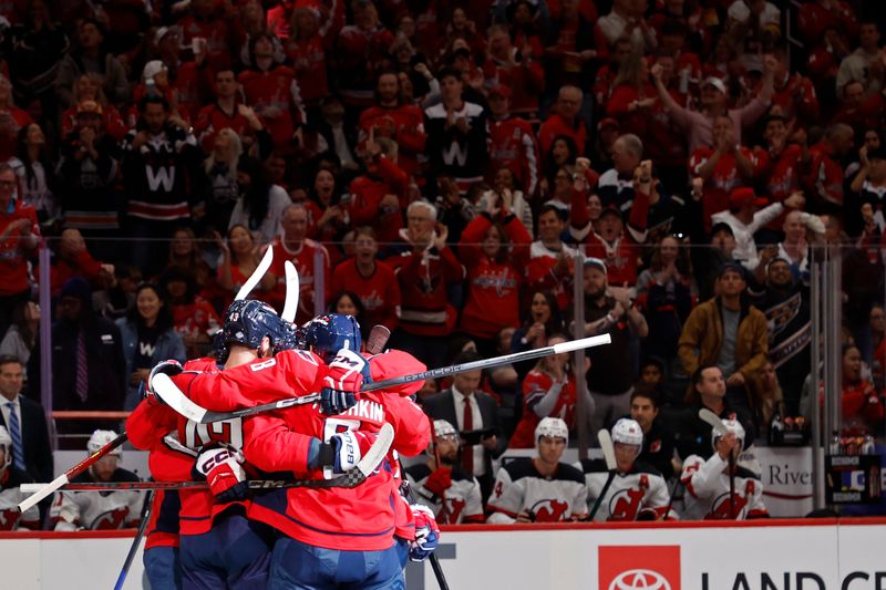 Oct 12, 2024; Washington, District of Columbia, USA; Washington Capitals defenseman John Carlson (74) celebrates with teammates after scoring a goal against the New Jersey Devils in the first period at Capital One Arena. Mandatory Credit: Geoff Burke-Imagn Images