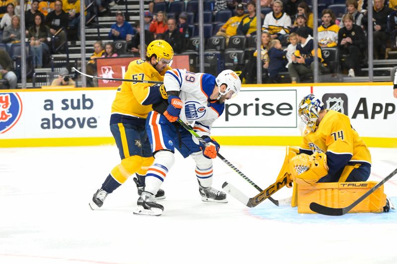 Oct 17, 2024; Nashville, Tennessee, USA;  Nashville Predators goaltender Juuse Saros (74) blocks the shot of Edmonton Oilers center Adam Henrique (19) during the second period at Bridgestone Arena. Mandatory Credit: Steve Roberts-Imagn Images