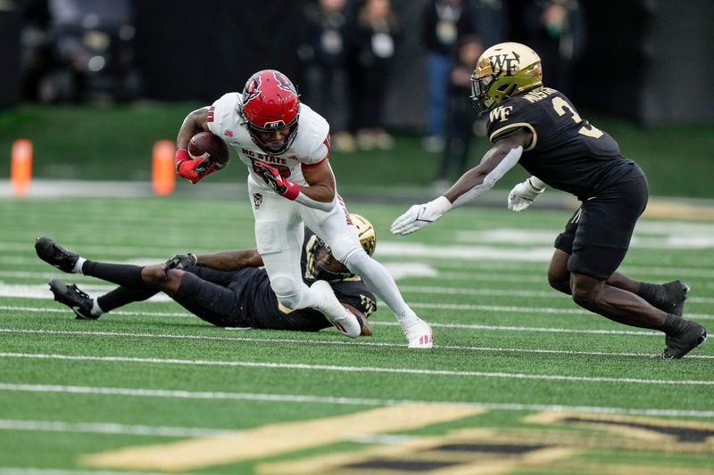 Nov 11, 2023; Winston-Salem, North Carolina, USA;  North Carolina State Wolfpack wide receiver Kevin Concepcion (10) runs past a tackle attempt by Wake Forest Demon Deacons defensive back DaShawn Jones (10) during the second half at Allegacy Federal Credit Union Stadium. Mandatory Credit: Jim Dedmon-USA TODAY Sports