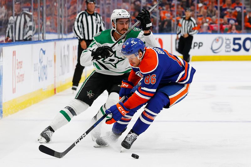 Jun 2, 2024; Edmonton, Alberta, CAN; Edmonton Oilers defensemen Philip Broberg (86) and Dallas Stars forward Mason Marchment (27) battle for a loose puck  during the second period in game six of the Western Conference Final of the 2024 Stanley Cup Playoffs at Rogers Place. Mandatory Credit: Perry Nelson-USA TODAY Sports