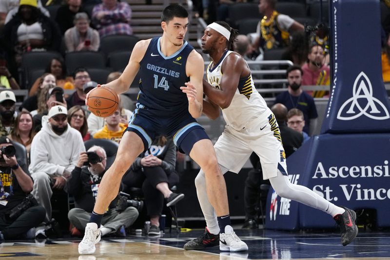 INDIANAPOLIS, INDIANA - OCTOBER 14: Zach Edey #14 of the Memphis Grizzlies posts up against Myles Turner #33 of the Indiana Pacers in the first quarter of  a preseason game at Gainbridge Fieldhouse on October 14, 2024 in Indianapolis, Indiana. NOTE TO USER: User expressly acknowledges and agrees that, by downloading and or using this photograph, User is consenting to the terms and conditions of the Getty Images License Agreement. (Photo by Dylan Buell/Getty Images)