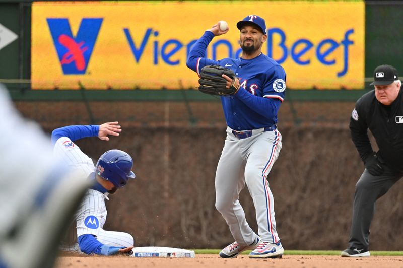 Apr 9, 2025; Chicago, Illinois, USA; Texas Rangers second baseman Marcus Semien (2) attempts a double play after forcing out Chicago Cubs first baseman Michael Busch (29) during the fourth inning at Wrigley Field. Mandatory Credit: Patrick Gorski-Imagn Images