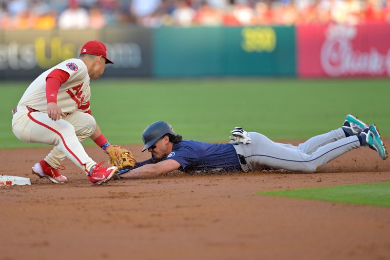 Jul 13, 2024; Anaheim, California, USA;  Josh Rojas #4 of the Seattle Mariners is caught stealing on tag by Keston Hiura #13 of the Los Angeles Angels in the second inning at Angel Stadium. Mandatory Credit: Jayne Kamin-Oncea-USA TODAY Sports