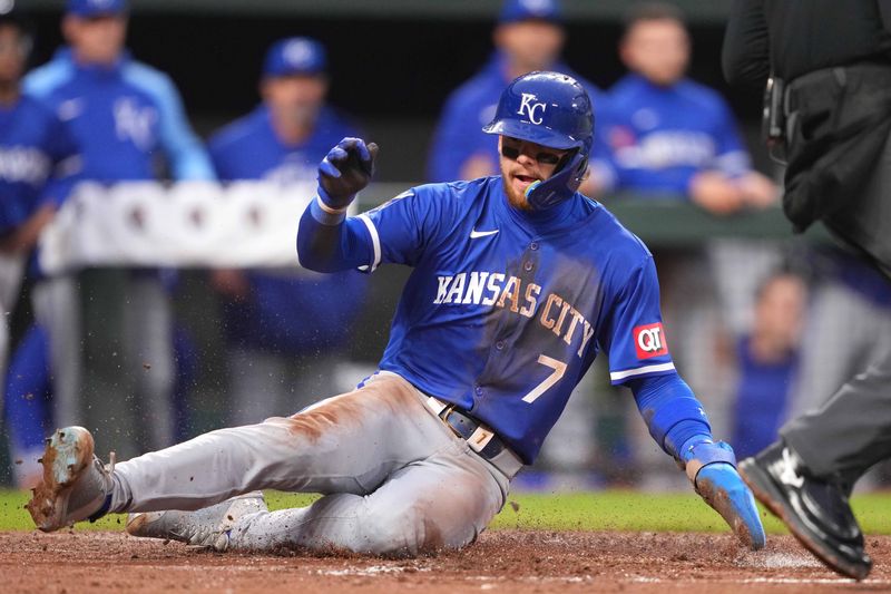 Apr 3, 2024; Baltimore, Maryland, USA; Kansas City Royals shortstop Bobby Witt Jr. (7) slides safely to score a run in third inning against the Baltimore Orioles at Oriole Park at Camden Yards. Mandatory Credit: Mitch Stringer-USA TODAY Sports