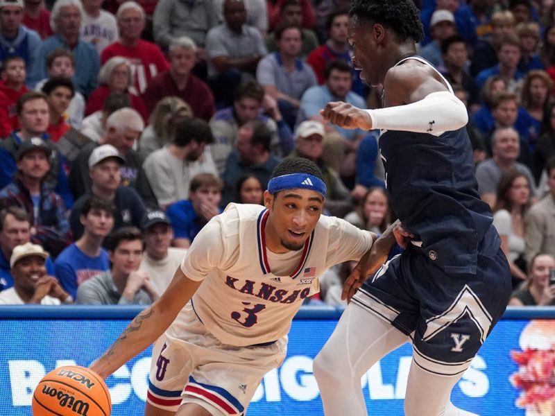 Dec 22, 2023; Lawrence, Kansas, USA; Kansas Jayhawks guard Dajuan Harris Jr. (3) dribbles the ball as Yale Bulldogs guard Bez Mbeng (2) defends during the second half at Allen Fieldhouse. Mandatory Credit: Denny Medley-USA TODAY Sports