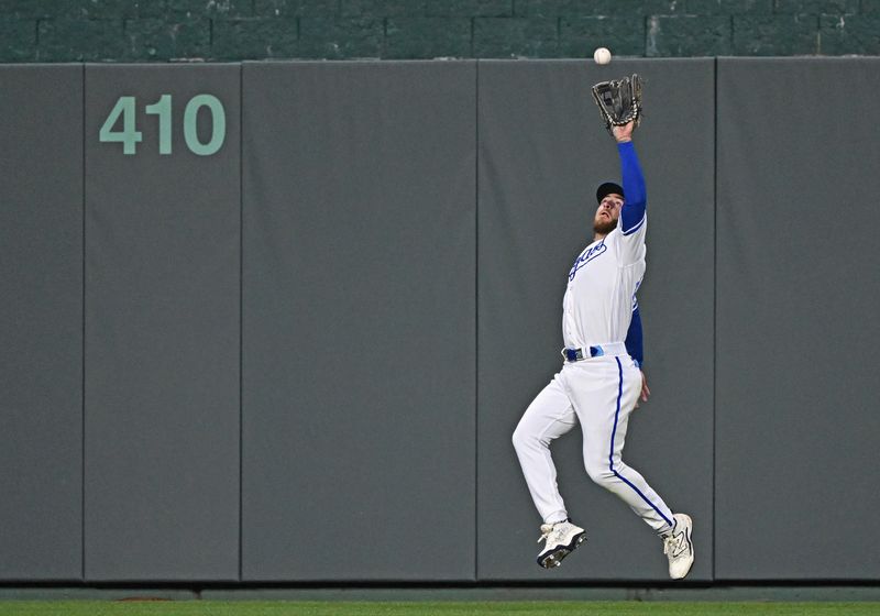 Apr 15, 2023; Kansas City, Missouri, USA;  Kansas City Royals center fielder Kyle Isbel (28) reaches back to catch the flay ball during the seventh inning against the Atlanta Braves at Kauffman Stadium. Mandatory Credit: Peter Aiken-USA TODAY Sports