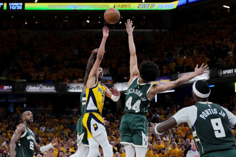 INDIANAPOLIS, INDIANA - APRIL 26: Tyrese Haliburton #0 of the Indiana Pacers attempts a shot while being fouled by Patrick Beverley #21 of the Milwaukee Bucks in overtime during game three of the Eastern Conference First Round Playoffs at Gainbridge Fieldhouse on April 26, 2024 in Indianapolis, Indiana. NOTE TO USER: User expressly acknowledges and agrees that, by downloading and or using this photograph, User is consenting to the terms and conditions of the Getty Images License Agreement. (Photo by Dylan Buell/Getty Images)