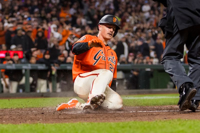 Jul 12, 2024; San Francisco, California, USA; San Francisco Giants third baseman Matt Chapman (26)] slides home to score against the Minnesota Twins during the seventh inning at Oracle Park. Mandatory Credit: John Hefti-USA TODAY Sports