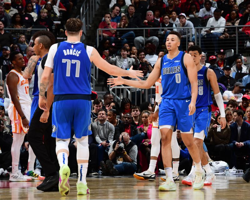 ATLANTA, GA - JANUARY 26: Luka Doncic #77 high fives Dante Exum #0 of the Dallas Mavericks during the game against the Atlanta Hawks on January 26, 2024 at State Farm Arena in Atlanta, Georgia.  NOTE TO USER: User expressly acknowledges and agrees that, by downloading and/or using this Photograph, user is consenting to the terms and conditions of the Getty Images License Agreement. Mandatory Copyright Notice: Copyright 2024 NBAE (Photo by Scott Cunningham/NBAE via Getty Images)