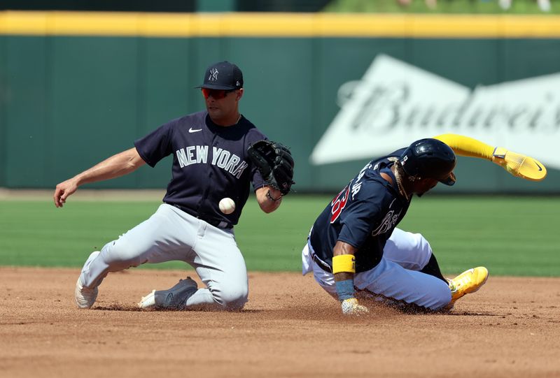 Mar 5, 2023; North Port, Florida, USA; Atlanta Braves right fielder Ronald Acuna Jr. (13) slides safely into second base as New York Yankees shortstop Isiah Kiner-Falefa (12) receives the throw at CoolToday Park. Mandatory Credit: Kim Klement-USA TODAY Sports