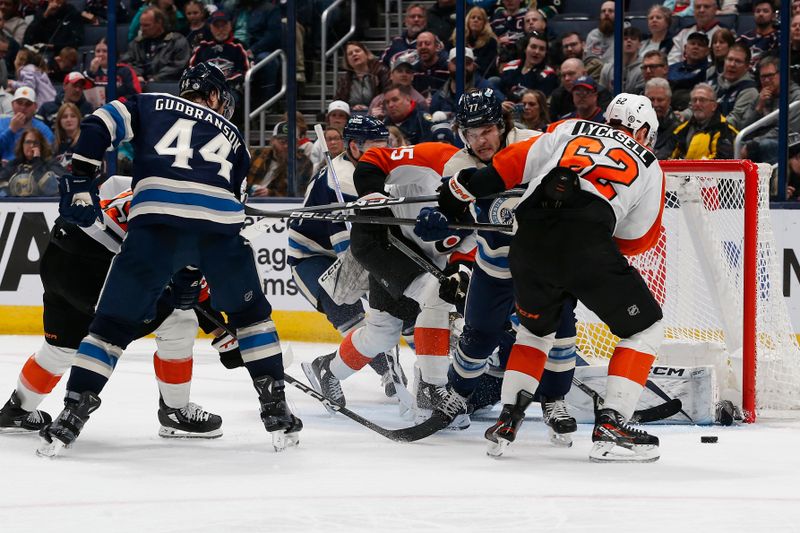 Apr 6, 2024; Columbus, Ohio, USA; Philadelphia Flyers right wing Olle Lycksell (62) reaches for the loose puck as Columbus Blue Jackets defenseman Nick Blankenburg (77)  defends during the second period at Nationwide Arena. Mandatory Credit: Russell LaBounty-USA TODAY Sports