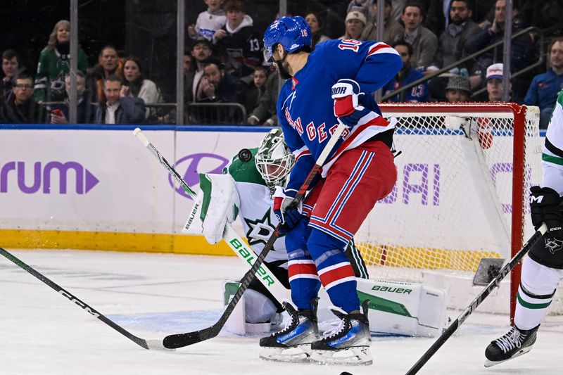 Jan 7, 2025; New York, New York, USA;  Dallas Stars goaltender Jake Oettinger (29) makes a save as New York Rangers center Vincent Trocheck (16) looks for a rebound during the third period at Madison Square Garden. Mandatory Credit: Dennis Schneidler-Imagn Images