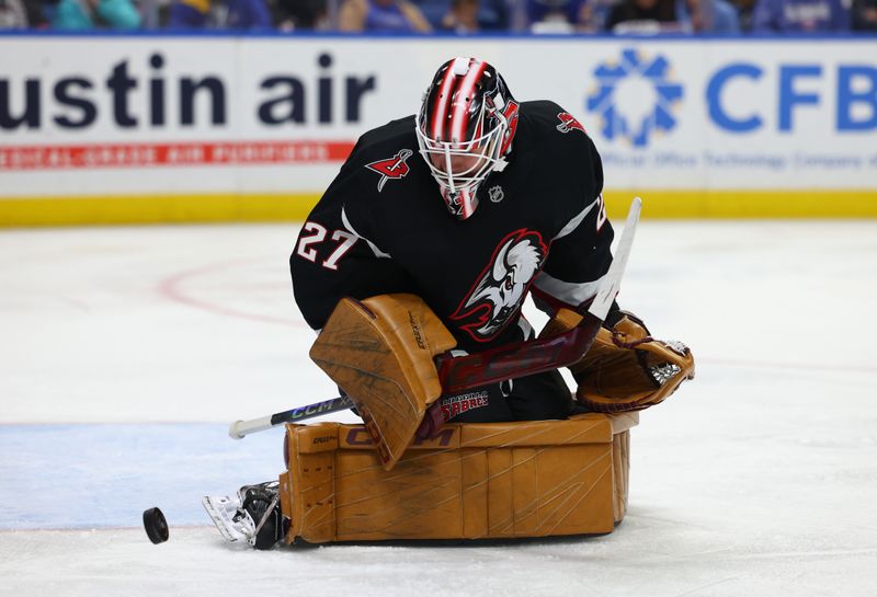 Nov 1, 2024; Buffalo, New York, USA;  Buffalo Sabres goaltender Devon Levi (27) makes a pad save during the first period against the New York Islanders at KeyBank Center. Mandatory Credit: Timothy T. Ludwig-Imagn Images