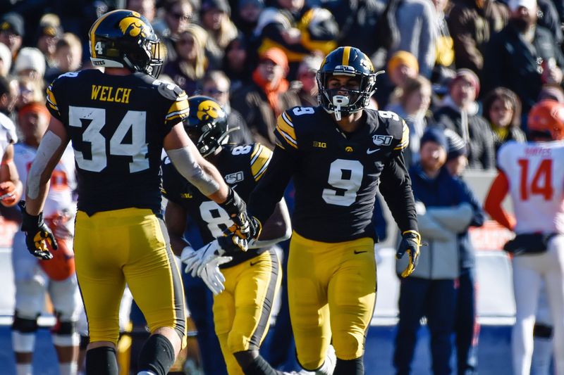 Nov 23, 2019; Iowa City, IA, USA; Iowa Hawkeyes defensive back Geno Stone (9) and linebacker Kristian Welch (34) react during the third quarter against the Illinois Fighting Illini at Kinnick Stadium. Mandatory Credit: Jeffrey Becker-USA TODAY Sports