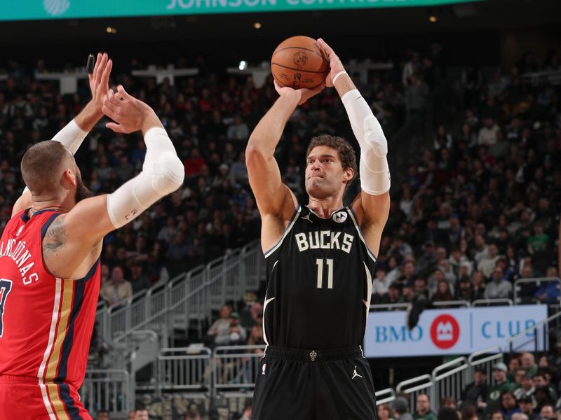 MILWAUKEE, WI - JANUARY 27:  Brook Lopez #11 of the Milwaukee Bucks shoots a three point basket during the game  on January 27, 2024 at the Fiserv Forum Center in Milwaukee, Wisconsin. NOTE TO USER: User expressly acknowledges and agrees that, by downloading and or using this Photograph, user is consenting to the terms and conditions of the Getty Images License Agreement. Mandatory Copyright Notice: Copyright 2024 NBAE (Photo by Gary Dineen/NBAE via Getty Images).