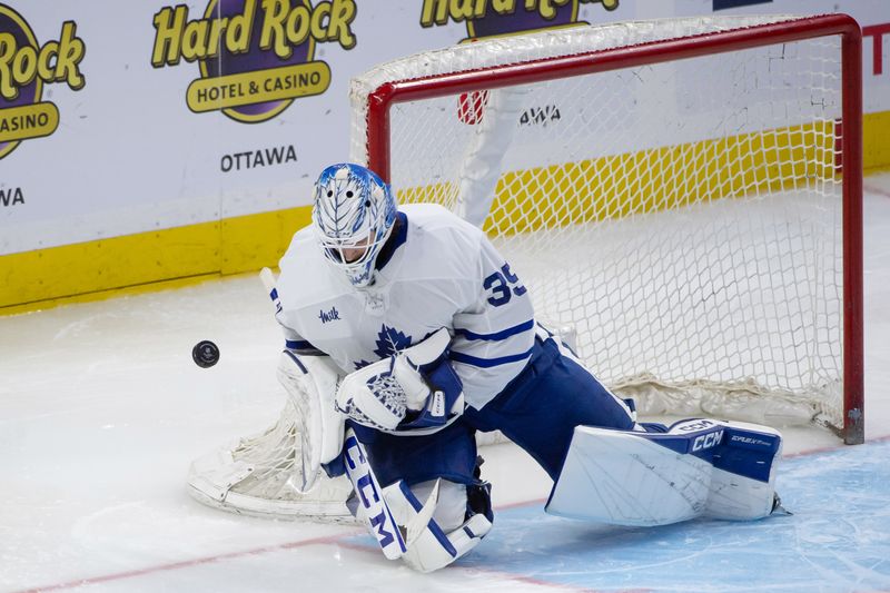 Sep 24, 2024; Ottawa, Ontario, CAN; Toronto Maple Leafs goalie Dennis Hildeby (35) makes a save in the third period against the Ottawa Senators at the Canadian Tire Centre. Mandatory Credit: Marc DesRosiers-Imagn Images