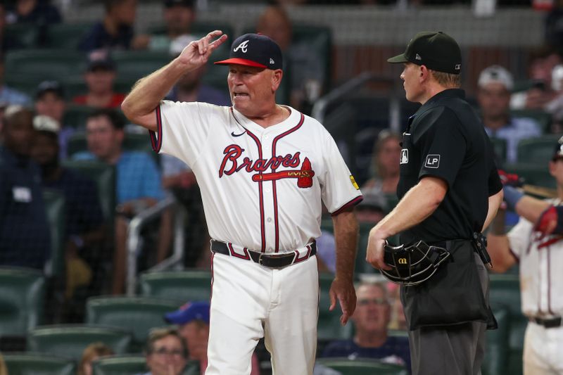 Aug 7, 2024; Atlanta, Georgia, USA; Atlanta Braves manager Brian Snitker (43) reacts to umpire Brian Walsh (120) after being ejected from a game against the Milwaukee Brewers in the fifth inning at Truist Park. Mandatory Credit: Brett Davis-USA TODAY Sports
